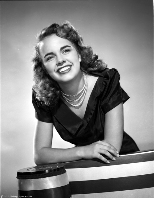Terry Moore Leaning and smiling Portrait in Classic Photo Print - Item # VARCEL702337