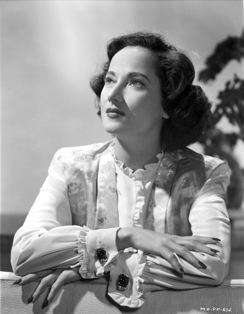 Merle Oberon on a Long Sleeve Top Kneeling Photo Print - Item # VARCEL702785