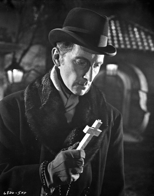 Film still of Peter Cushing holding a cross outdoors Photo Print - Item # VARCEL688935