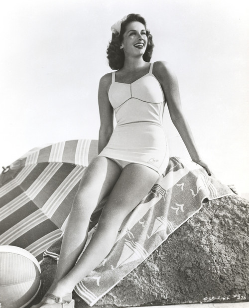 Jinx Falkenburg sitting on a Big Rock, wearing a One Piece Photo Print - Item # VARCEL688990