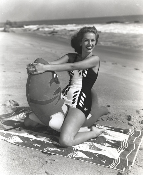 Jinx Falkenburg sitting on a Life Buoy on the Beach Photo Print - Item # VARCEL688991