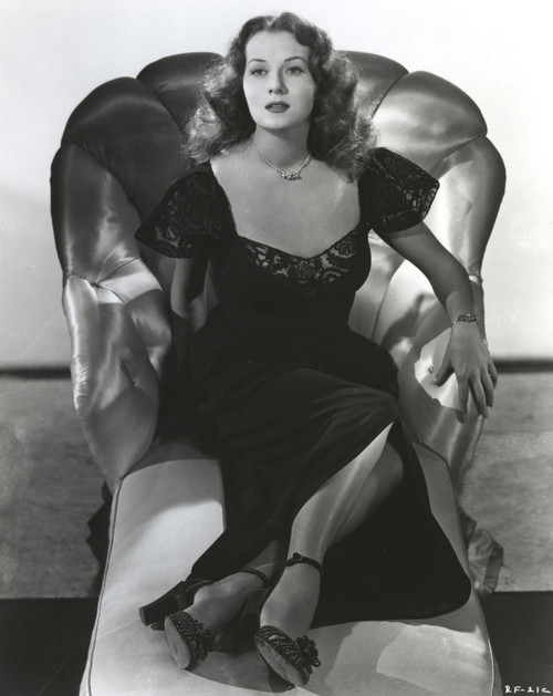 Rhonda Fleming Relaxing on a Couch wearing a Black Gown Photo Print - Item # VARCEL689163