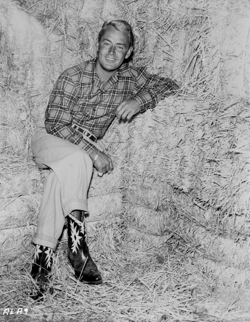 Alan Ladd sitting on a Hay Stack Portrait in Classic Photo Print - Item # VARCEL689804