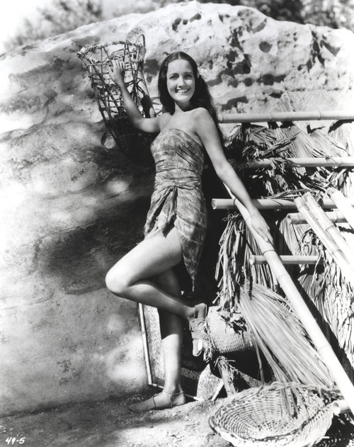 Dorothy Lamour wearing a wrap dress next to a lean to Photo Print - Item # VARCEL689902