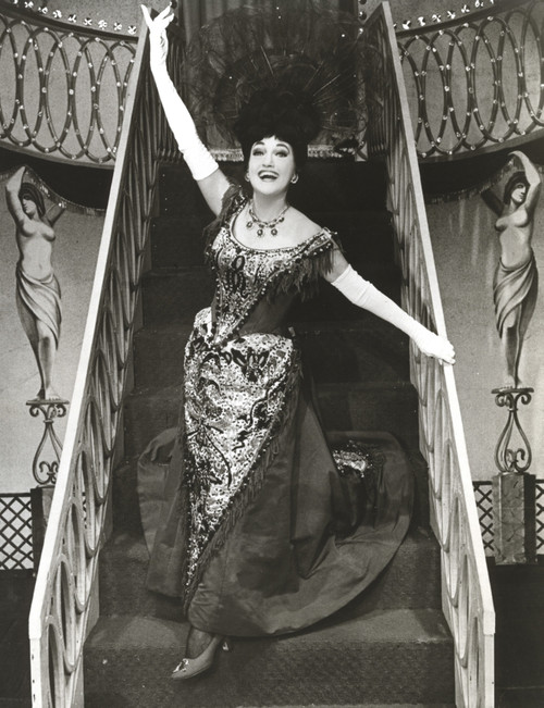 Dorothy Lamour descending stairs wearing a headdress Photo Print - Item # VARCEL689932