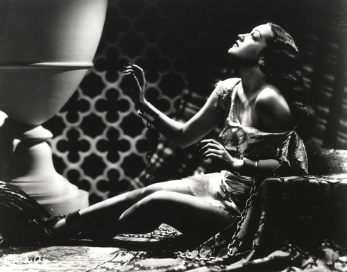 Dorothy Lamour in chains posing with an urn Photo Print - Item # VARCEL689943