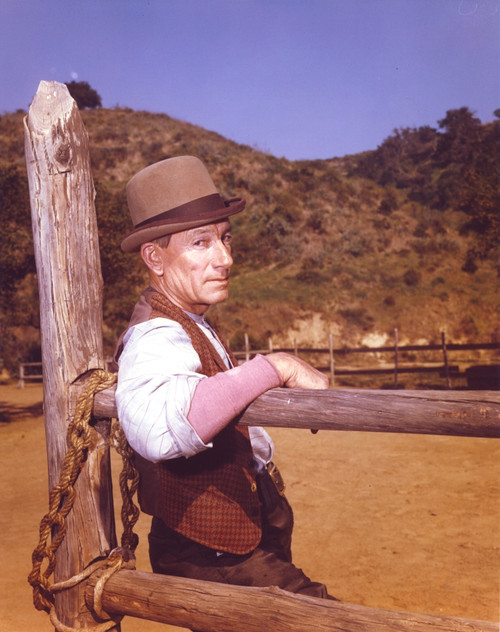 Laramie Cast Leaning on Wood in Cowboy Outfit Photo Print - Item # VARCEL690057