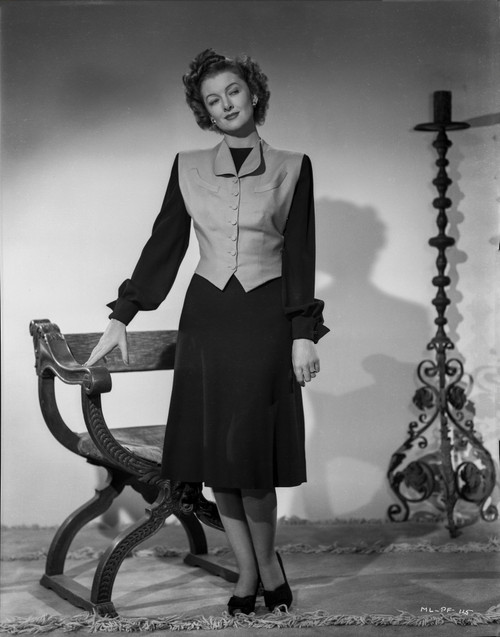 Myrna Loy standing in Long Sleeve Dress with Vest Photo Print - Item # VARCEL690573