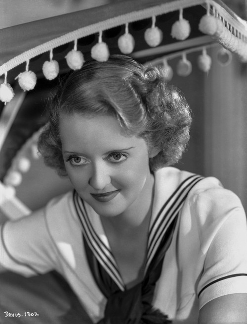 Bette Davis Portrait Seated in White Short Sleeve Sailor Uniform with Black Scarf Tied Loose Photo Print - Item # VARCEL692988