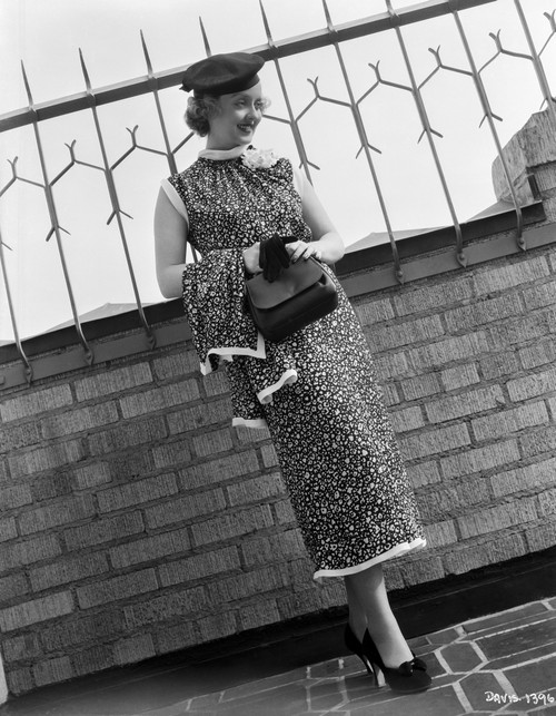 Bette Davis Posed with Bag on Hand in Black Polka Dot Sleeveless Dress and Black Flat Cap Photo Print - Item # VARCEL693022