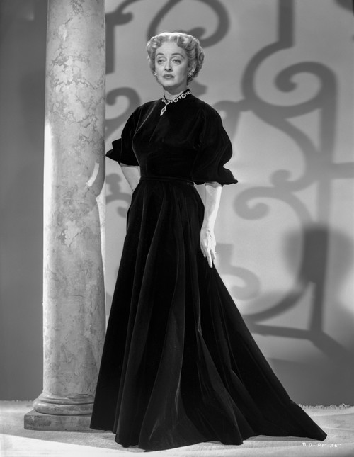 Bette Davis Posed Hands on the Waist in Ruffled Short Sleeve High Neck Black Dress Photo Print - Item # VARCEL693042