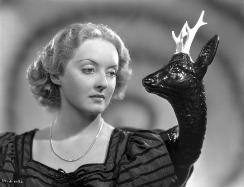Bette Davis Portrait Looking at a Deer Figure in Black Short Sleeve Dress and Necklace Photo Print - Item # VARCEL693077