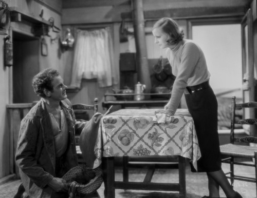 Greta Garbo Leaning on the Table to Talk to a Man Photo Print - Item # VARCEL693144