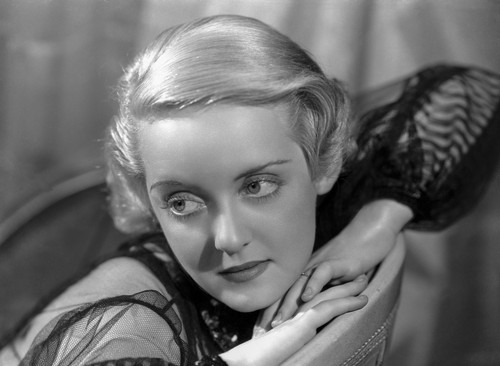 Bette Davis Portrait with Head Leaning on the Hands in Black Slashed Long Sleeve Sheer Dress Photo Print - Item # VARCEL693159