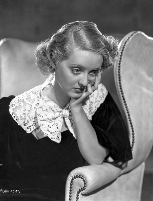 Bette Davis Seated Looking Down with Chin Leaning on Hand in Black Dress with White Broad Lace Collar Photo Print - Item # VARCEL693163