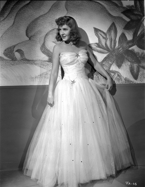Jean Arthur Posed in White Strapless Silk Dress with Pleated Sheer Skirt with Head Turn to the Right Photo Print - Item # VARCEL693177
