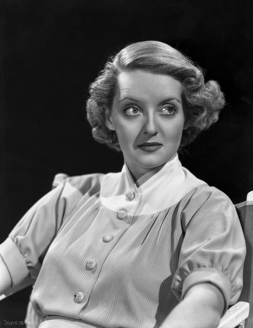 Bette Davis Seated while Looking to the Left in White High Neck Folded Short Sleeves Shirt Photo Print - Item # VARCEL693184