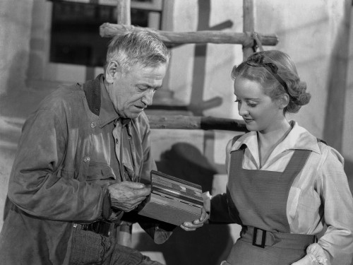 Bette Davis Scene from a Film standing in White Long Sleeve Shirt and Apron Photo Print - Item # VARCEL693233