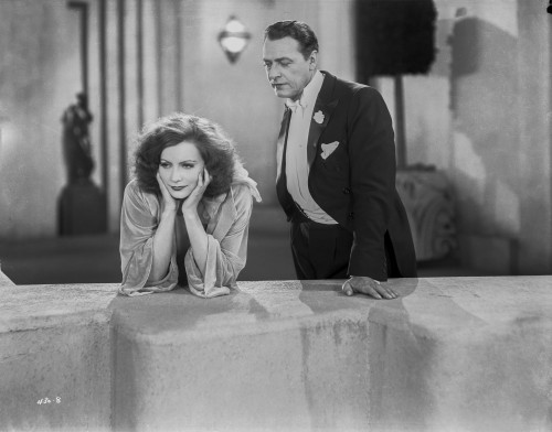 Greta Garbo Leaning while a Mans Talking Photo Print - Item # VARCEL693301