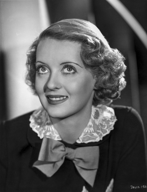 Bette Davis Portrait in White Silk Collar Black Long Sleeve and Ribbon with Marcel Wave Curls Photo Print - Item # VARCEL693317