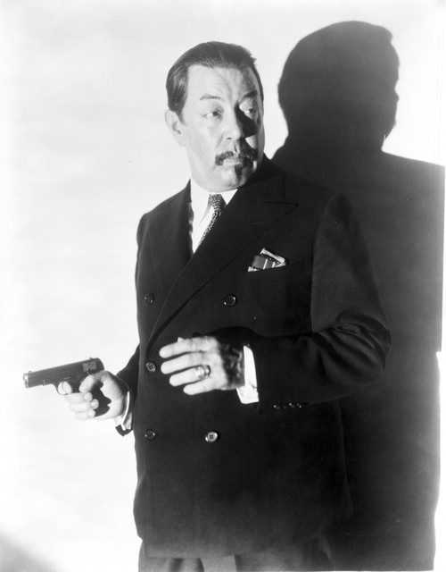Warner Oland holding a gun Photo Print - Item # VARCEL693320