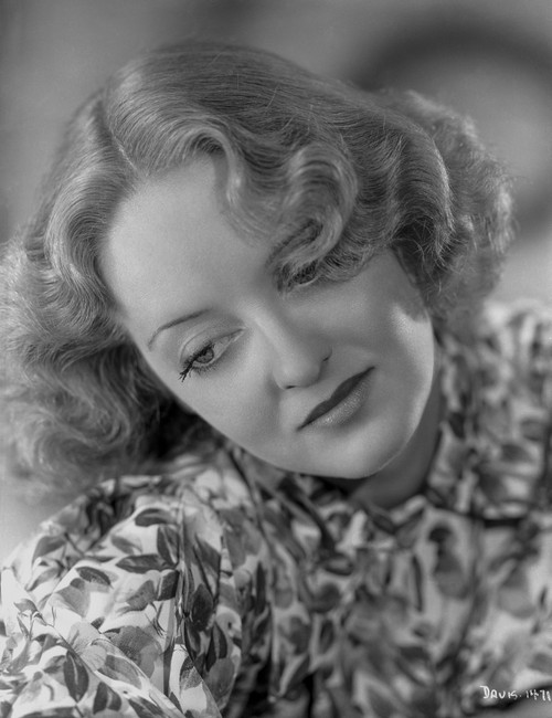 Bette Davis Portrait Looking Down in Floral Shirt and Middle Parted Marcel Wave Photo Print - Item # VARCEL693368