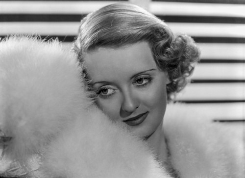 Bette Davis Portrait with Leaning to the Right in White Fur Boa and White Fur Pelted Dress Photo Print - Item # VARCEL693406