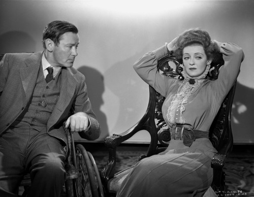 Bette Davis Scene from a Film Seated on a Chair with Hands on the Head in High Neck Long Sleeve Dress with scarf Photo Print - Item # VARCEL693488