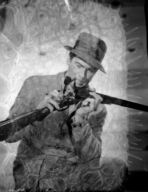 Walter Pidgeon loading a gun Photo Print - Item # VARCEL693550
