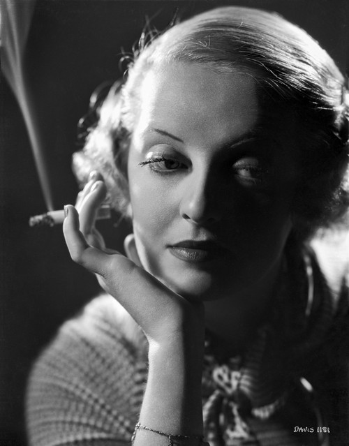 Bette Davis Portrait Chin Leaning on Hand with Cigarette in White Knitted Shirt Photo Print - Item # VARCEL693598