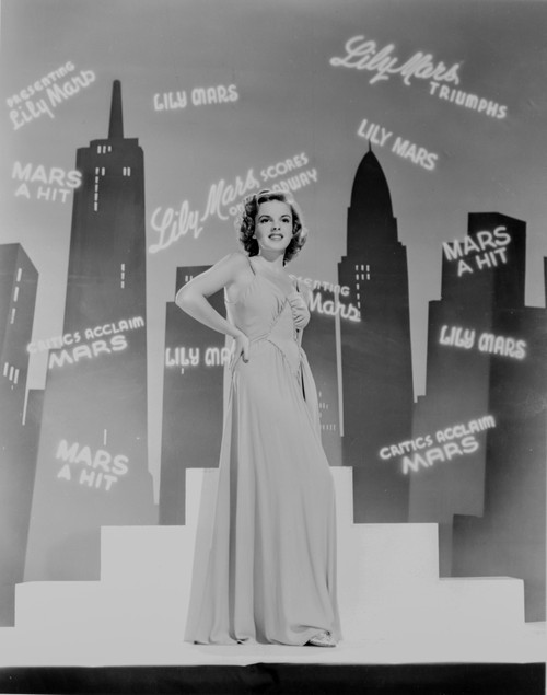 Judy Garland dancing infront of shadows of skyline +tograph High Photo Print - Item # VARCEL694044