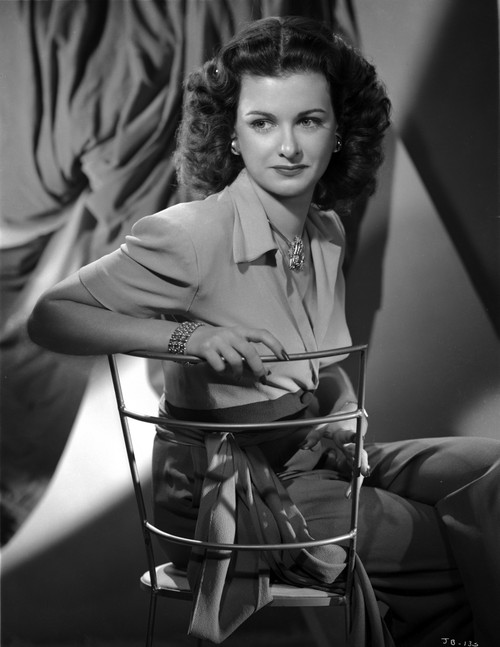 Joan Bennett sitting and Crossing Legs Portrait Photo Print - Item # VARCEL694094