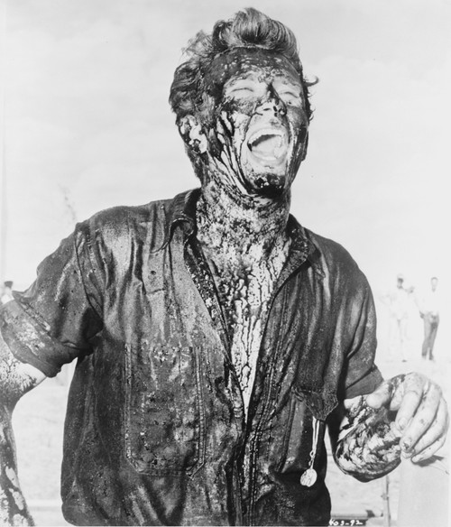 James Dean Posed in Black Short Sleeve Collar Shirt with Head Raised Up and Mouth Open while Stained with Blood All Over the Body Photo Print - Item # VARCEL694134