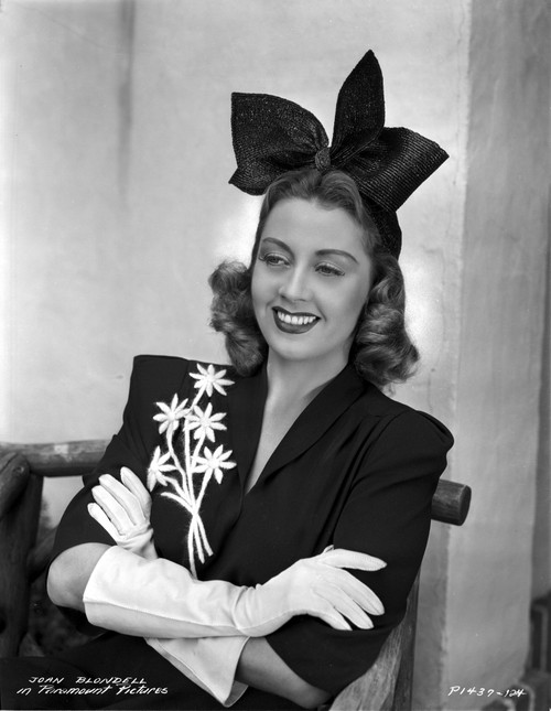 Joan Blondell on an Embroidered Top and sitting Photo Print - Item # VARCEL694351