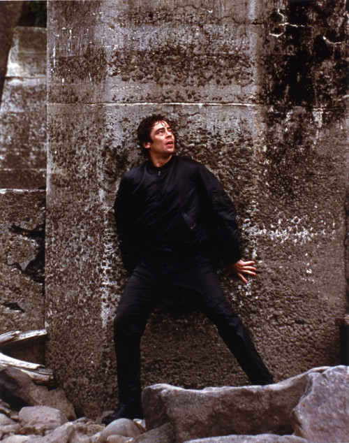 Benicio Del Toro Leaning on Wall in Black Coat Photo Print - Item # VARCEL694559