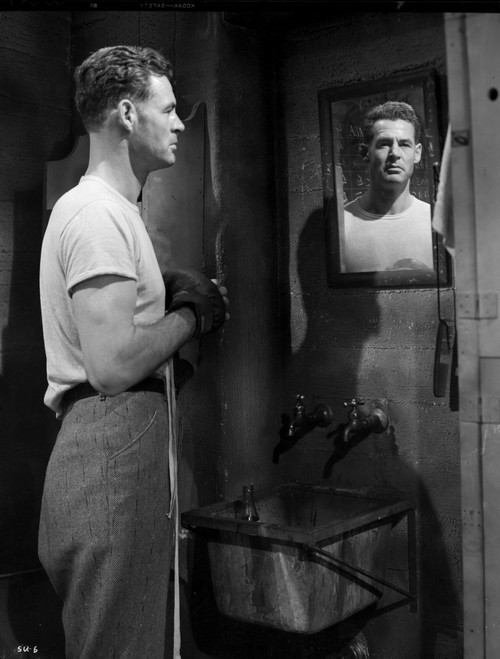 A Film Still Of Robert Ryan Looking at Reflection in Mirror Photo Print - Item # VARCEL694614