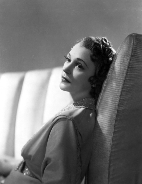 Alice Brady sitting on the Sofa wearing Blouse Photo Print - Item # VARCEL694676