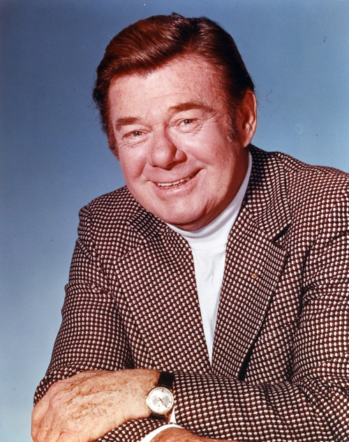 Portrait of Arthur Godfrey Posed in Coat with Blue Background Photo Print - Item # VARCEL694864