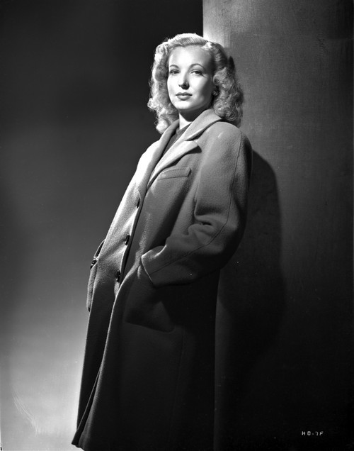 Hillary Brooks Leaning on Post in Coat Photo Print - Item # VARCEL694907