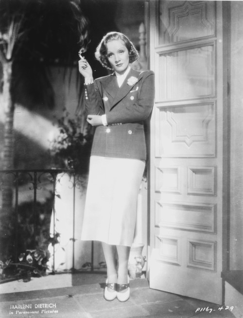 Marlene Dietrich standing in Police Uniform with Cigarette Photo Print - Item # VARCEL695277
