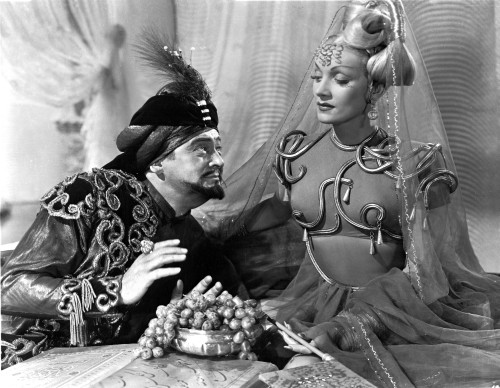 Marlene Dietrich sitting with Man in Detailed Dress with Veil Photo Print - Item # VARCEL695313