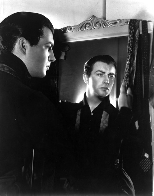 A Publicity Still Of Robert Taylor Next To A Mirror Photo Print - Item # VARCEL695467