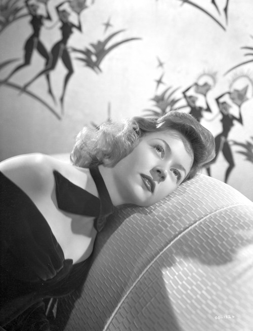 Gloria Grahame Curly Hair Lying on Couch in Black Gown with Tie Photo Print - Item # VARCEL695729