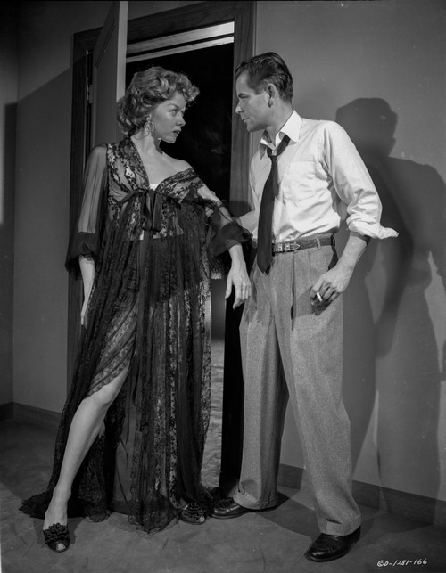 Human Desire Man in Polo and Tie Holding a Woman in Dress Photo Print - Item # VARCEL703216