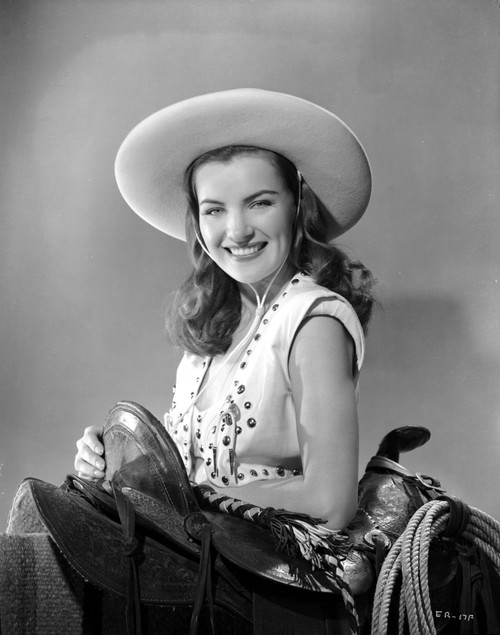 Ella Raines smiling in Cowgirl Outfit Photo Print - Item # VARCEL703415
