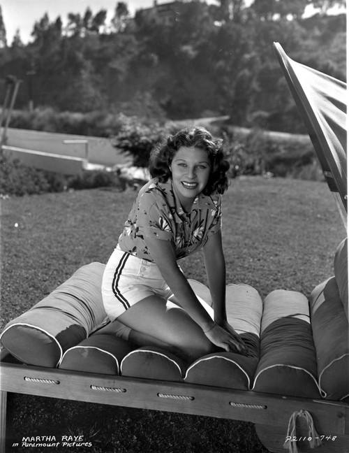 Martha Raye sitting on a Couch in Printed Top Photo Print - Item # VARCEL703495