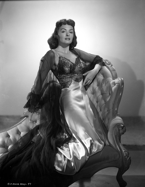 Donna Reed on a Dress Kneeling on Couch in Black and White Photo Print - Item # VARCEL703566
