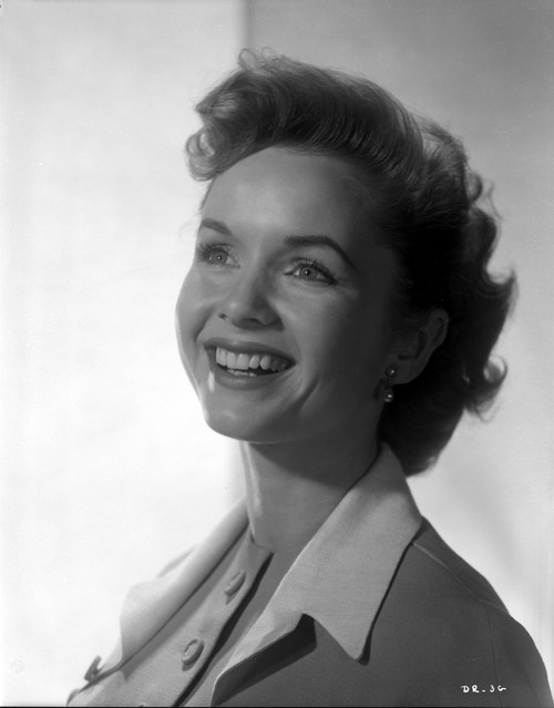 Debbie Reynolds smiling in a White Trench Coat Photo Print - Item # VARCEL703617