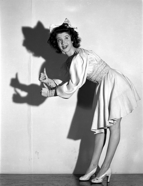 Peggy Ryan Bending Over with Thumbs Up wearing Lace Dress Photo Print - Item # VARCEL704116