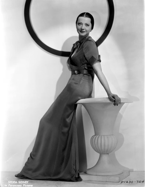 Sylvia Sidney sitting and posed in Gown Photo Print - Item # VARCEL704475